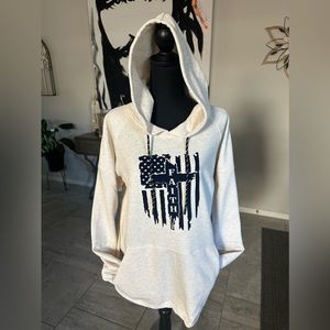 A hoodie sweater with the American flag, and the words faith of across
